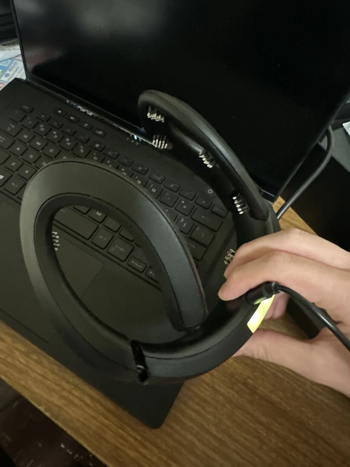 The Crown headset plugged into a laptop, its electrode prongs visible